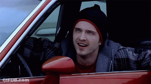 Man In Black Beanie And Plaid Shirt In Red Car GIF