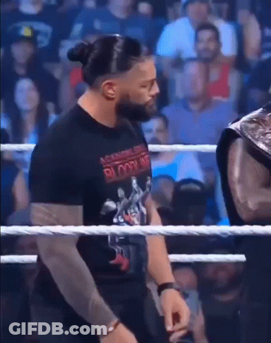 Man In Black Bloodline Shirt In Wrestling Ring GIF