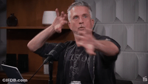 Man In Black Boston Shirt Gesturing GIF