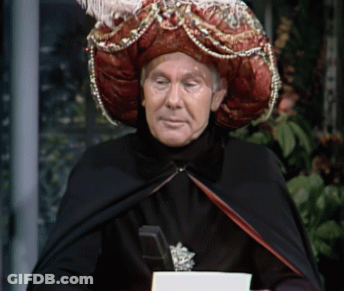 Man In Black Cape And Red Hat Holding Book GIF