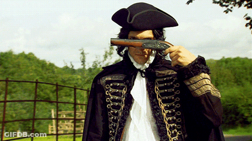 Man In Black Cape Holding Gun Over Face GIF