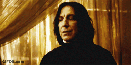 Man In Black Cape Holding Pot Before Crowd GIF