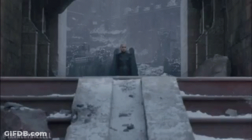 Man In Black Cape On Snowy Staircase GIF