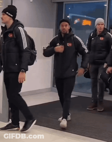 Man In Black CCM Hat Walking With Two Men GIF