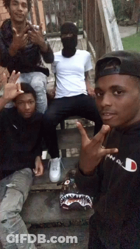Man In Black Champion Hoodie Posing With Friends GIF