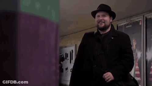 Man In Black Coat And Hat With 4 Sign GIF