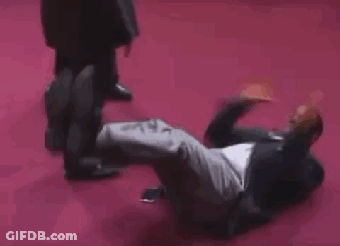 Man In Black Coat And High Heels On Stage GIF