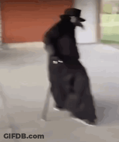 Man In Black Coat And Top Hat On White Chair GIF