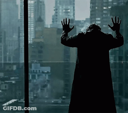Man In Black Coat Hands Up At Window GIF