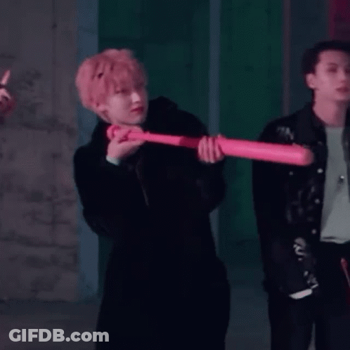 Man In Black Coat Holding Pink Baseball Bat GIF
