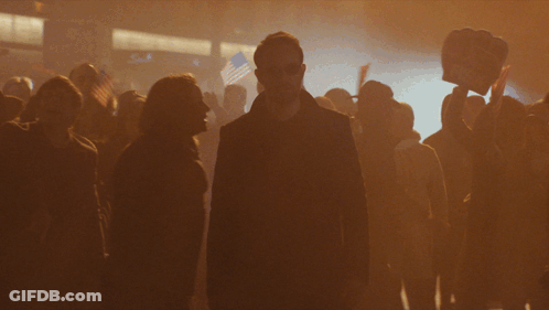 Man In Black Coat In Crowd GIF