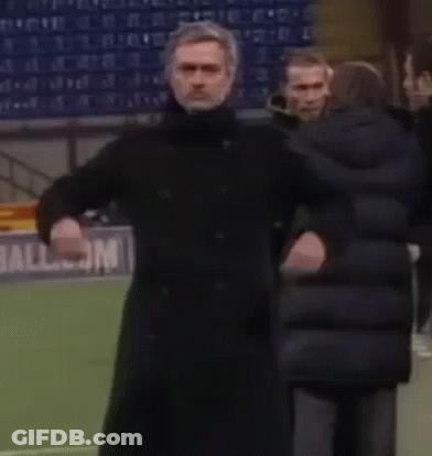 Man In Black Coat In Front Of All.com Sign GIF
