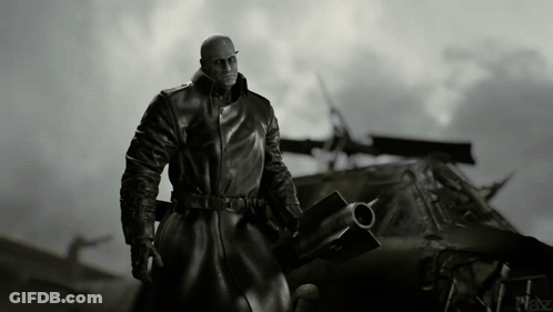 Man In Black Coat In Front Of Military Vehicle GIF