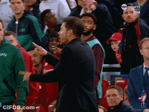 Man In Black Coat In Front Of Red Digi Seat GIF