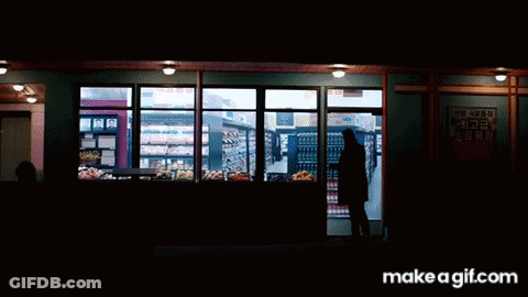 Man In Black Coat Looking At Grocery Shelves GIF