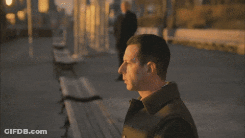 Man In Black Coat On Sidewalk GIF
