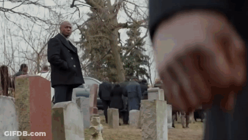 Man In Black Coat Standing In Cemetery With Crowd GIF