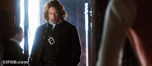 Man In Black Coat Standing In Hallway GIF