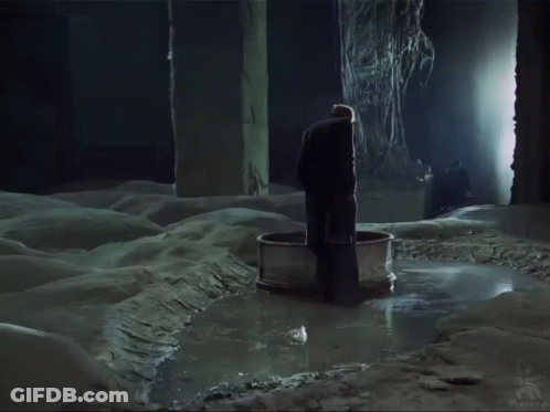 Man In Black Coat Standing In Water GIF