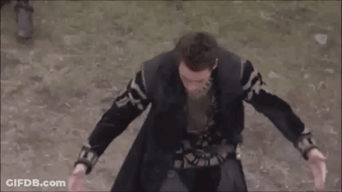 Man In Black Coat Standing On Dirt Field GIF