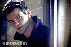 Man In Black Coat Standing GIF