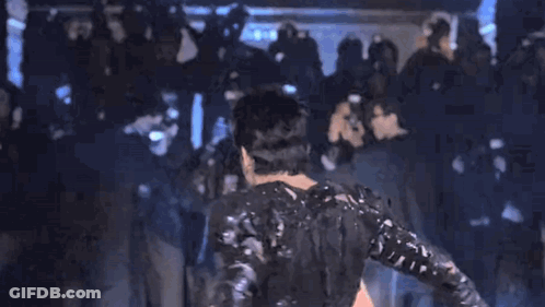 Man In Black Costume Blue Background GIF
