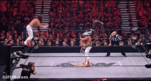 Man In Black Crew Shirt Photographing Wrestling Match GIF
