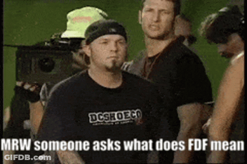 Man In Black DC Shoes Shirt In Crowd GIF