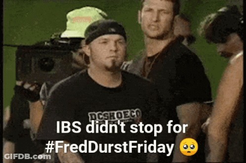 Man In Black DCSHOECO Shirt In Crowd GIF