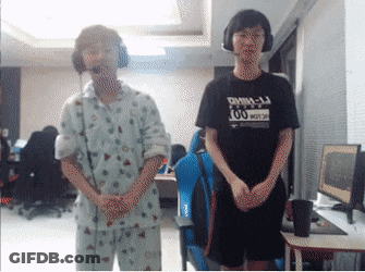 Man In Black DMM-LJ Shirt Next To Man In Pajamas GIF