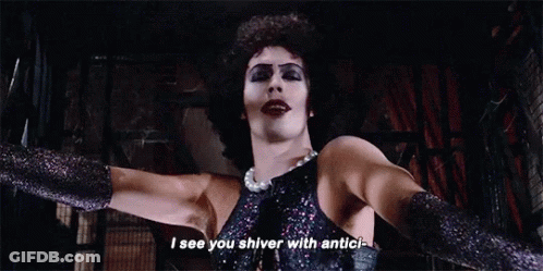 Man In Black Dress And Gloves Standing With Arms Outstretched GIF