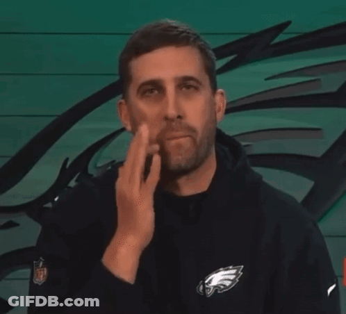 Man In Black Eagles Sweatshirt Wiping Face GIF
