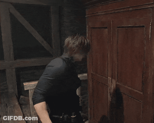 Man In Black Gloves Reaching Into Shelf GIF