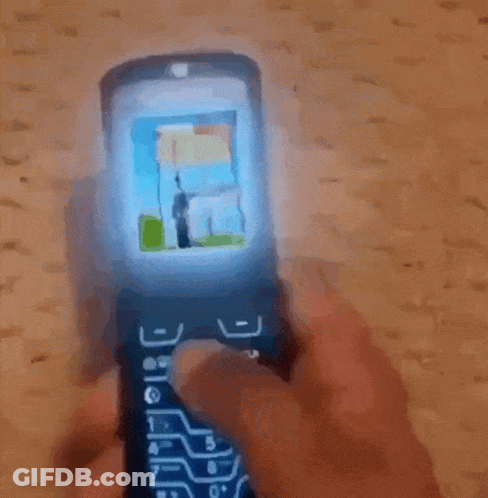 Man In Black Guess Jacket Looking At Phone GIF