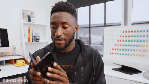 Man In Black Guess Jacket Looking At Phone GIF