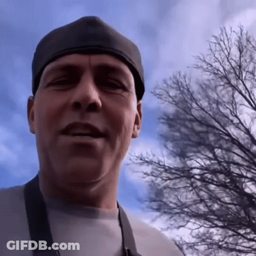 Man In Black Hat And Apron Looking At Camera GIF