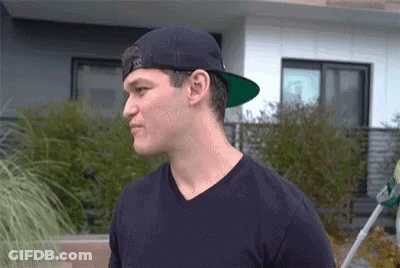 Man In Black Hat And Black Shirt Before House GIF