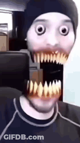Man In Black Hat And Black Shirt With Large Mouth And Teeth GIF