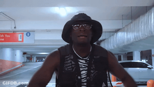 Man In Black Hat And Glasses In Parking Garage GIF