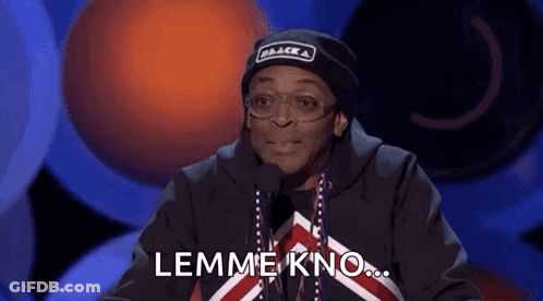 Man In Black Hat And Glasses Talking Into Microphone Saying Lemme Kno GIF
