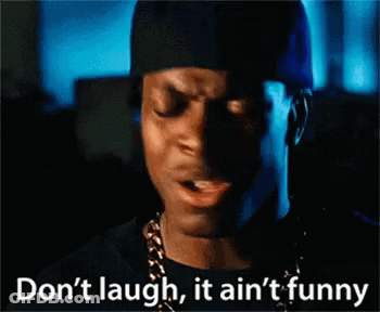 Man In Black Hat And Gold Chain Says Don't Laugh It Ain't Funny GIF