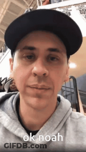 Man In Black Hat And Grey Hoodie Saying OK Noah GIF