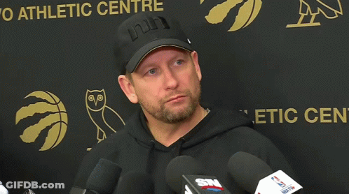 Man In Black Hat And Hoodie At Athletic Center Sign GIF