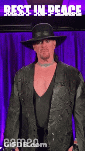 Man In Black Hat And Jacket Says Rest In Peace GIF