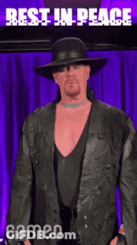 Man In Black Hat And Leather Jacket Says Rest In Peace GIF