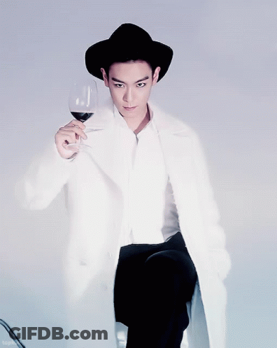 Man In Black Hat And White Coat Holding Wine GIF