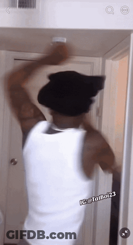 Man In Black Hat And White Tank Top Ig @ Tatubo123 GIF