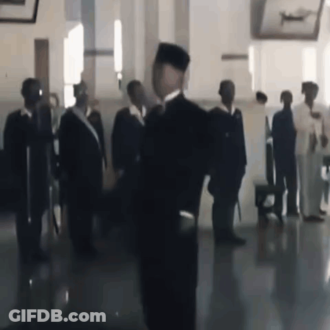 Man In Black Hat Before Group Of Men GIF