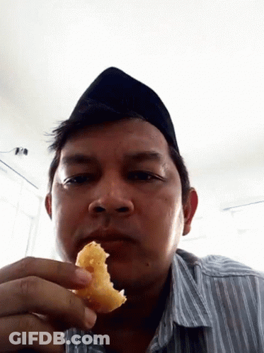Man In Black Hat Holding Food GIF