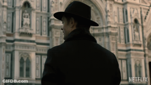 Man In Black Hat In Front Of Netflix Building GIF
